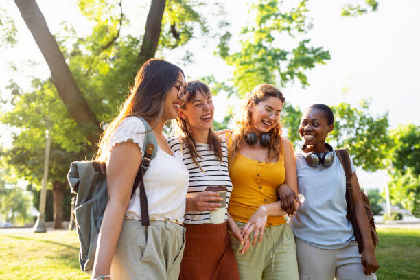 istock Modern multiracial female University students walking through the campus park 2158539130