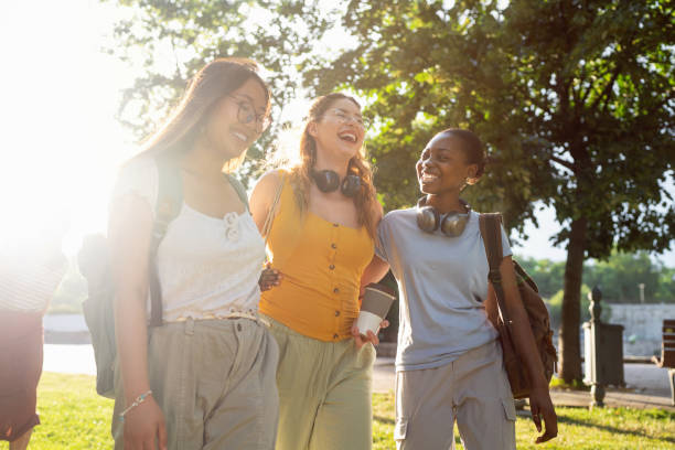 istock Modern multiracial female University students walking through the campus park 2158539136