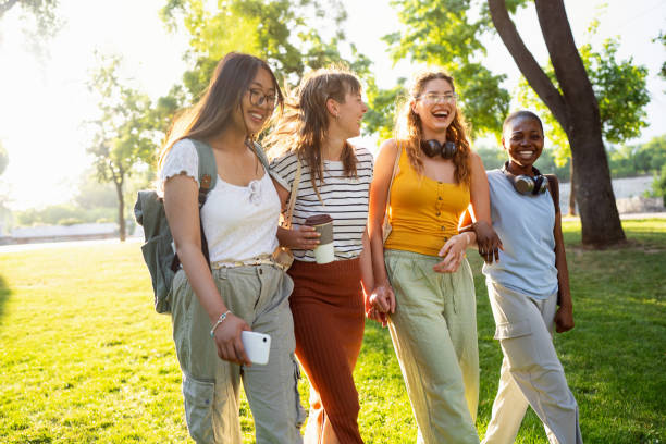 istock Modern multiracial female University students walking through the campus park 2158539140