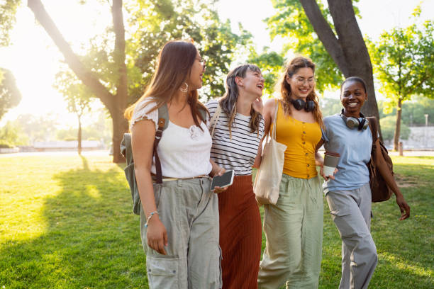 istock Modern multiracial female University students walking through the campus park 2158539195