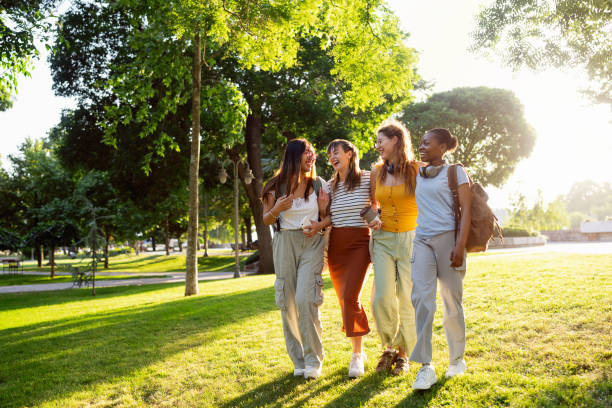 istock Group of modern multiracial female University students walking through the campus park 2158539224