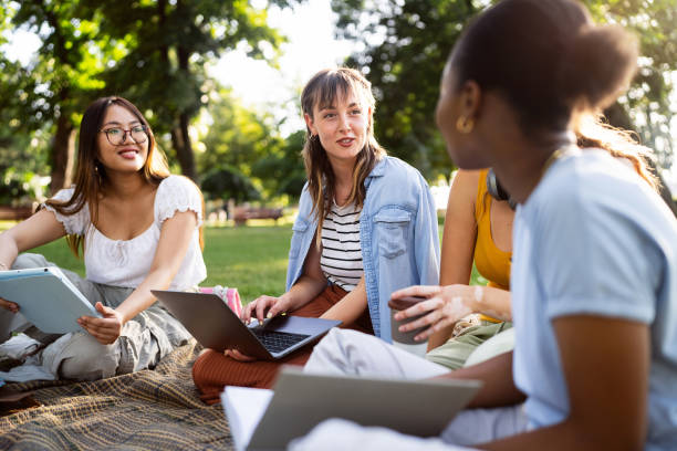 istock Multiracial female University students studying together at the campus park 2158539258
