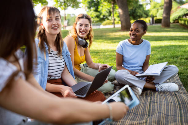 istock Multiracial female University students studying together at the campus park 2158539261