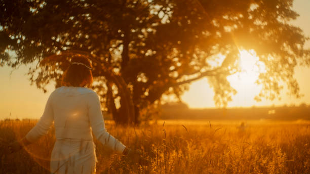 istock Serene Evening Stroll by Mature Woman in Meadow 2158539265
