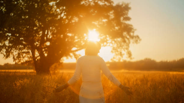 istock Serene Sunset Stroll: Mature Woman Interacting with Nature 2158539268