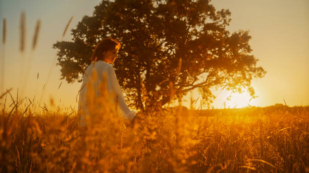 istock Serene Mature Woman in Sunset Meadow 2158539309