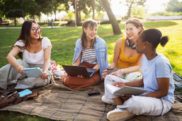 istock Modern multiracial female University students studying together at the campus park 2158539328