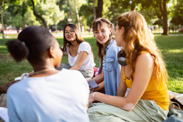 istock Multiracial female University students studying together at the campus park 2158539343