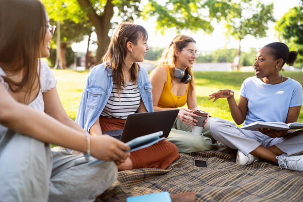 istock Multiracial female University students studying together at the campus park 2158539354