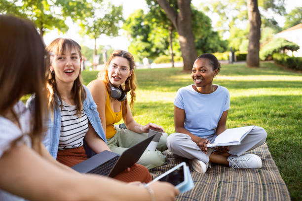 istock Modern multiracial female University students studying together at the campus park 2158539483