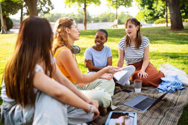 istock At the campus park, modern multiracial female University students studying together 2158539611