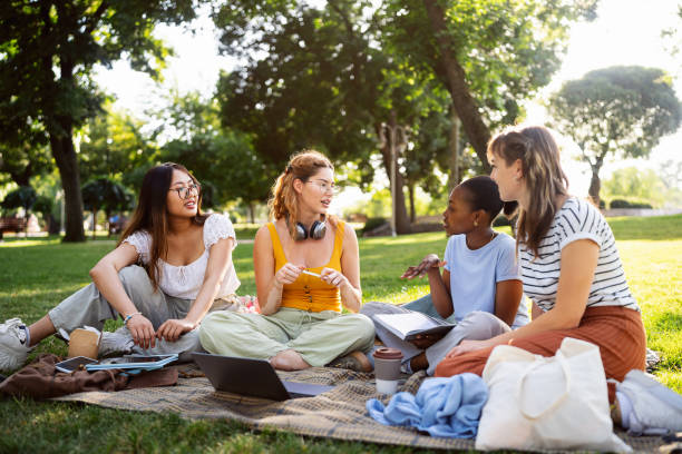 istock At the campus park, modern multiracial female University students studying together 2158539628