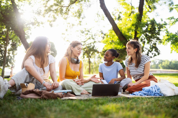 istock Multiracial female University students studying together at the campus park 2158539822