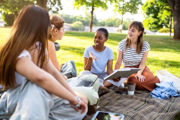 istock Multiracial female University students studying together at the campus park 2158539827