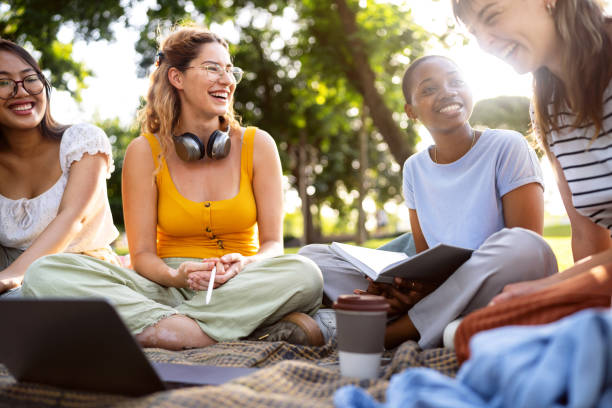 istock Multiracial female University students studying together at the campus park 2158539867