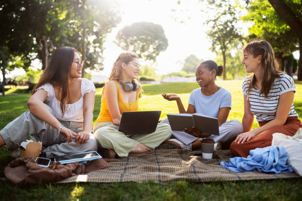 istock Multiracial female University students studying together at the campus park 2158539937