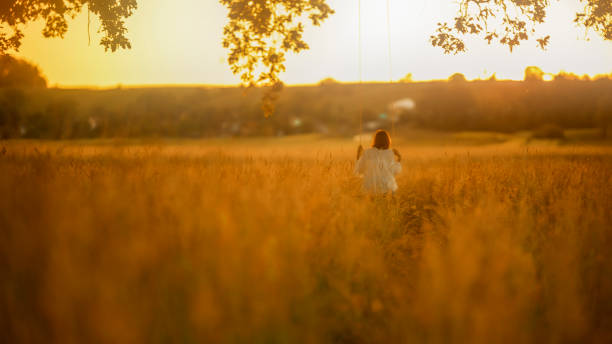 istock Girl on Swing During Golden Hour 2158540086