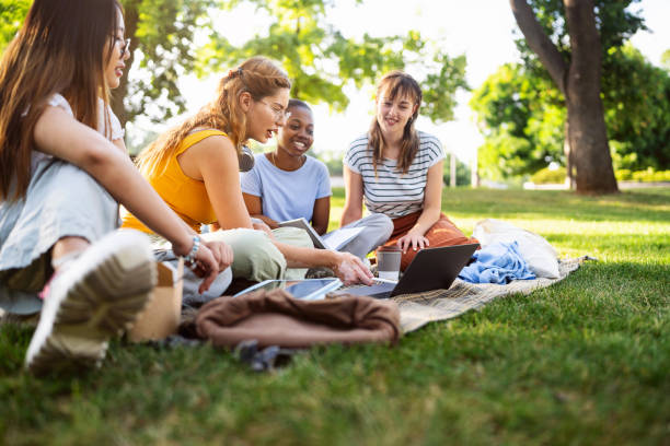 istock At the campus park, modern multiracial female University students studying together 2158540278