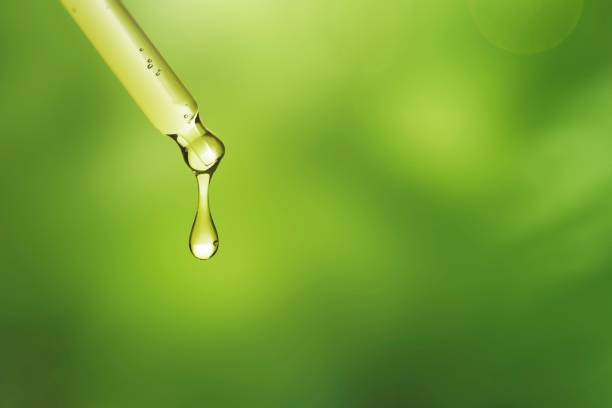 istock Green abstract background, dropper bottle with yellow solution wallpaper 2158541434