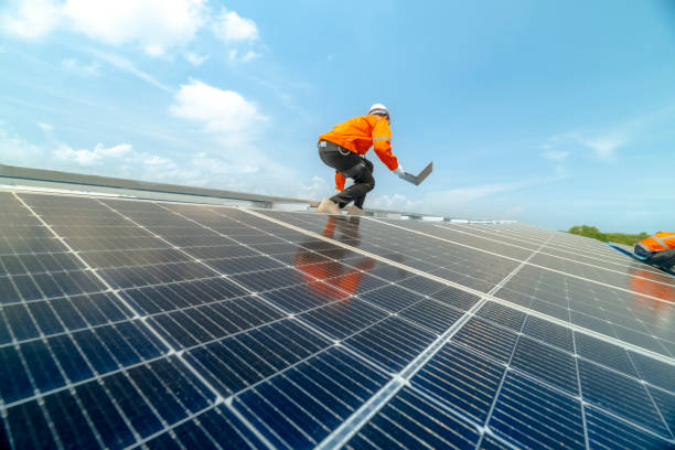 istock engineer man inspects construction of solar cell panel or photovoltaic cell by electronic device. Industrial Renewable energy of green power. factory worker working on tower roof. 2158541733
