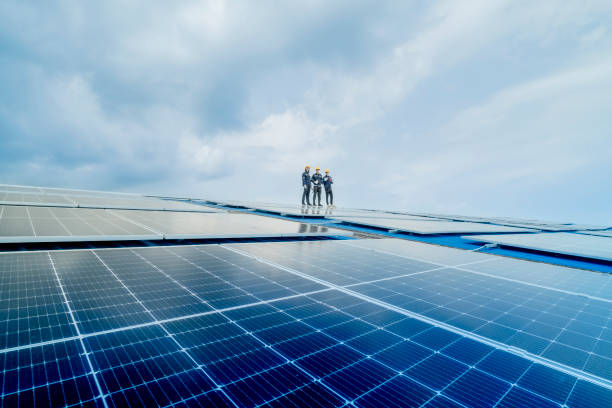 istock engineer man inspects construction of solar cell panel or photovoltaic cell by electronic device. Industrial Renewable energy of green power. factory worker working on tower roof. 2158541789
