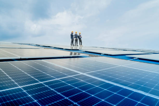 istock engineer man inspects construction of solar cell panel or photovoltaic cell by electronic device. Industrial Renewable energy of green power. factory worker working on tower roof. 2158541827