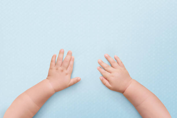 istock Baby hands blue background wallpaper 2158541846