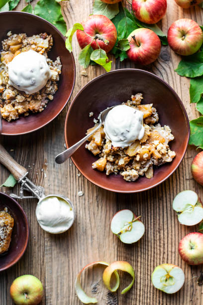 istock Delicious apple crumble vanilla ice cream on wooden table 2158542118