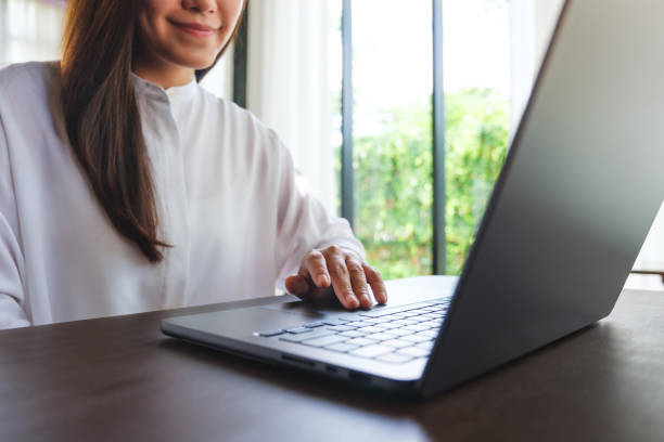 istock Closeup image of a woman working and touching on laptop computer touchpad 2158542230