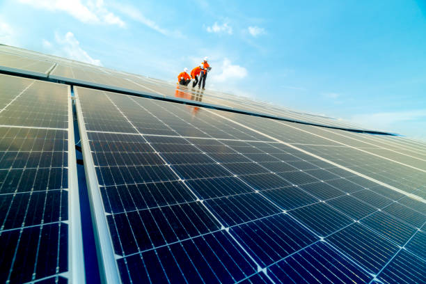 istock engineer man inspects construction of solar cell panel or photovoltaic cell by electronic device. Industrial Renewable energy of green power. factory worker working on tower roof. 2158542411