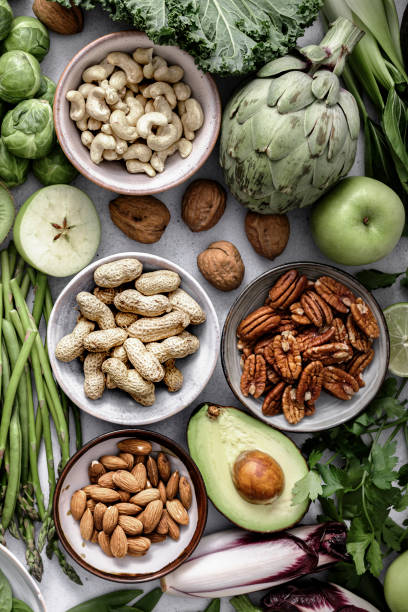istock Fresh vegetables with mixed nuts flat lay healthy diet 2158542447