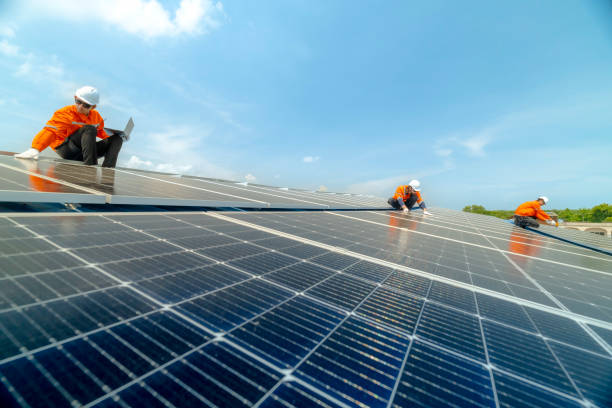 istock engineer man inspects construction of solar cell panel or photovoltaic cell by electronic device. Industrial Renewable energy of green power. factory worker working on tower roof. 2158542522