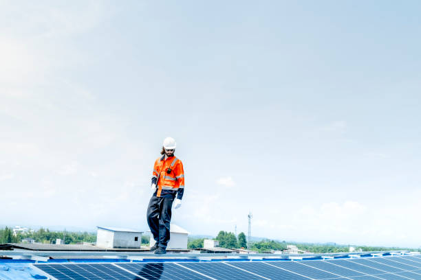 istock engineer man inspects construction of solar cell panel or photovoltaic cell by electronic device. Industrial Renewable energy of green power. factory worker working on tower roof. 2158542916