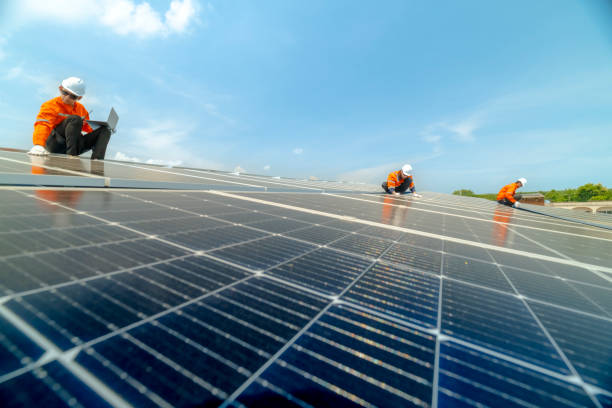 istock engineer man inspects construction of solar cell panel or photovoltaic cell by electronic device. Industrial Renewable energy of green power. factory worker working on tower roof. 2158542973