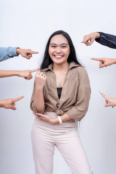 istock A happy and dependable woman vouched by her teammates. Arms from anonymous people pointing at her. Endorsed, vouched and recommended by coworkers. 2158543349