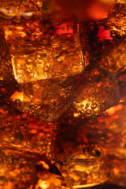 istock Cold carbonated drink over ice cubes in a glass close up 2158544265