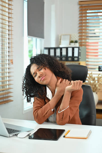 istock Tired and overworked African entrepreneur suffering from neck pain while after long hours work 2158545890