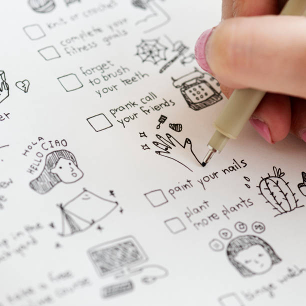 istock Girl doodling and making a checklist in a notebook 2158547576