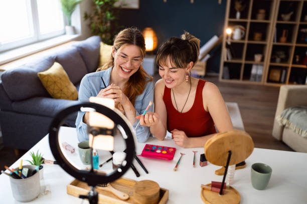 istock Two young women, influencers, recording a make-up tutorial for their vlog. 2158547624