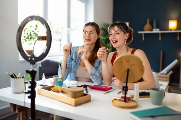 istock Two young women, influencers, recording a make-up tutorial for their vlog. 2158547806