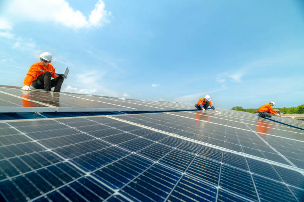 istock engineer man inspects construction of solar cell panel or photovoltaic cell by electronic device. Industrial Renewable energy of green power. factory worker working on tower roof. 2158547818