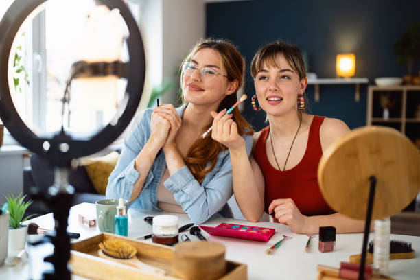 istock Two young women, influencers, recording a make-up tutorial for their vlog. 2158547862
