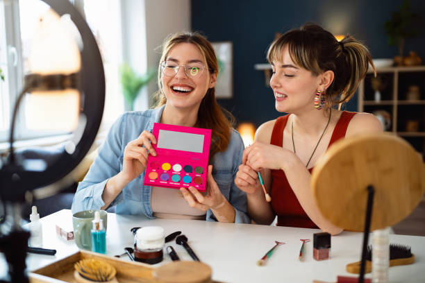 istock Two young women, influencers, recording a make-up tutorial for their vlog. 2158547983