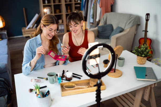 istock Two young women, influencers, recording a make-up tutorial for their vlog. 2158548055