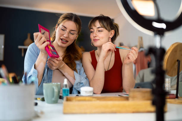 istock Two young women, influencers, recording a make-up tutorial for their vlog. 2158548095