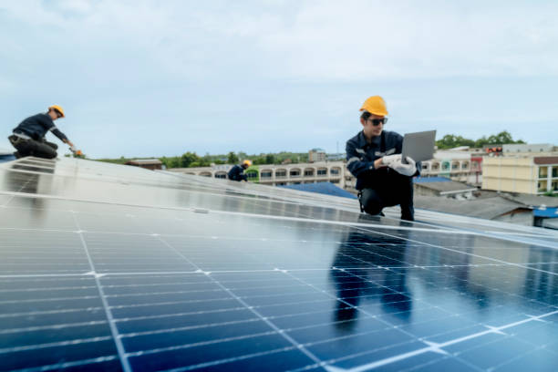 istock engineer man inspects construction of solar cell panel or photovoltaic cell by electronic device. Industrial Renewable energy of green power. factory worker working on tower roof. 2158548606