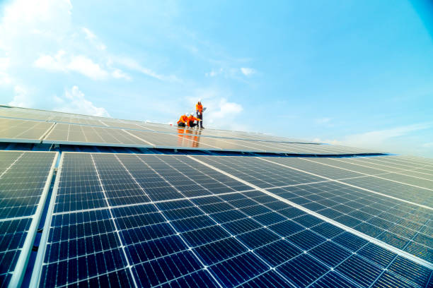 istock engineer man inspects construction of solar cell panel or photovoltaic cell by electronic device. Industrial Renewable energy of green power. factory worker working on tower roof. 2158549134