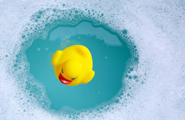 istock Yellow rubber duck in water with soap foam 2158549164