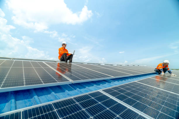 istock engineer man inspects construction of solar cell panel or photovoltaic cell by electronic device. Industrial Renewable energy of green power. factory worker working on tower roof. 2158549304