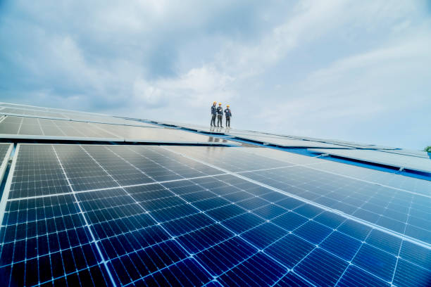 istock engineer man inspects construction of solar cell panel or photovoltaic cell by electronic device. Industrial Renewable energy of green power. factory worker working on tower roof. 2158549857